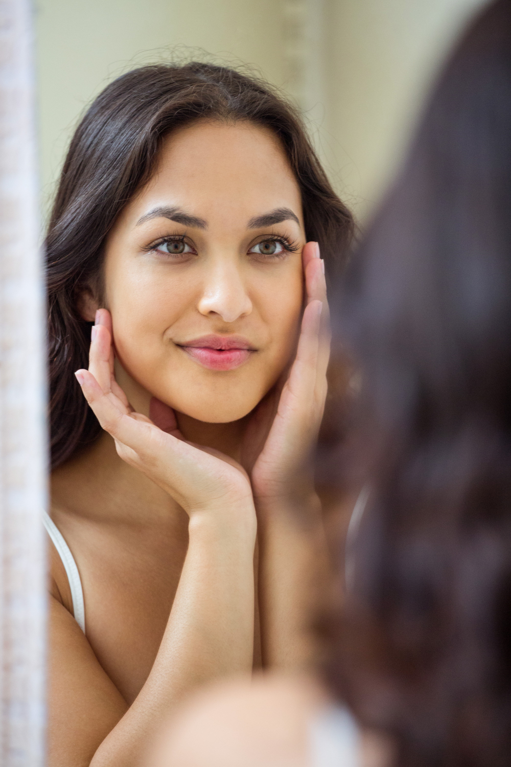 young-woman-looking-mirror-bathroom